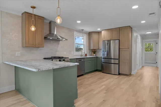 a kitchen with a sink a refrigerator and window