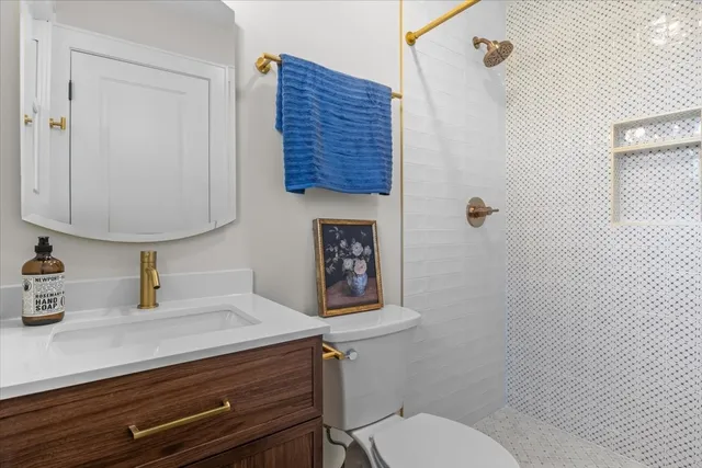 a bathroom with a toilet a sink and mirror