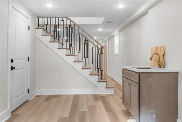 a view of entryway and hall with wooden floor