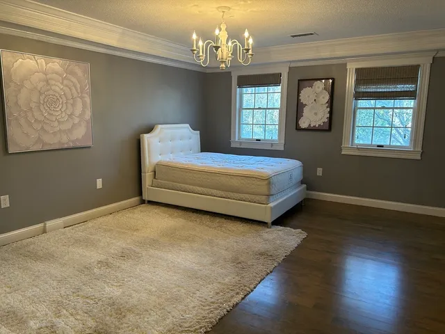 a spacious bedroom with a bed and window