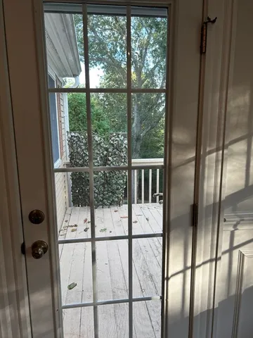 a view of entryway and hall with wooden floor