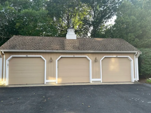 a front view of house with yard space and trees