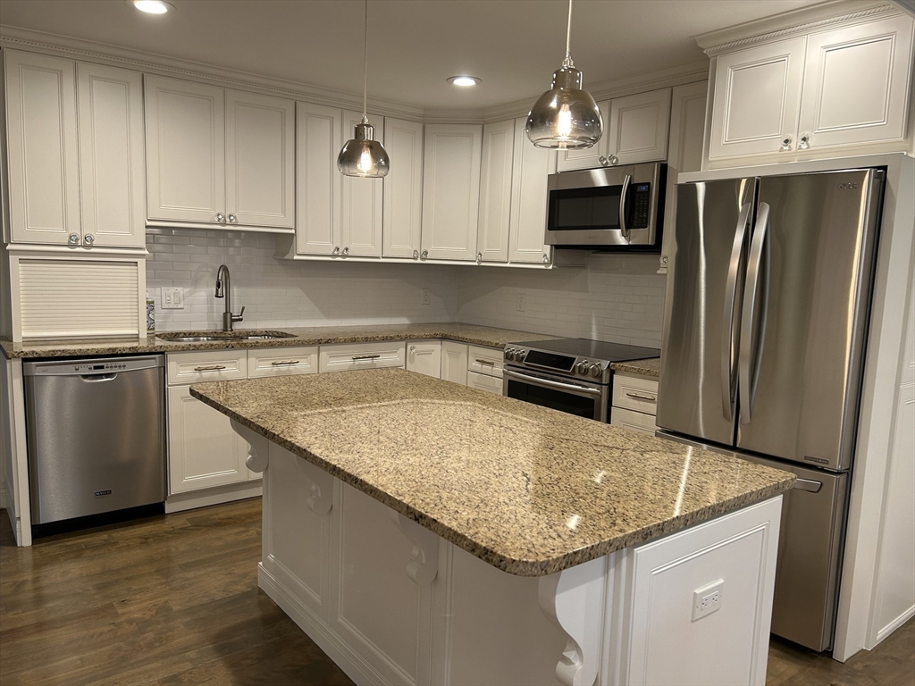 71 Weatherly Drive, Unit 71 Salem, MA 01970 - Photo 8 of 29 a kitchen with stainless steel appliances granite countertop a sink dishwasher a refrigerator and a stove