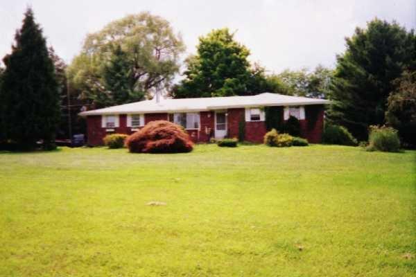 a view of a house with a yard and garage