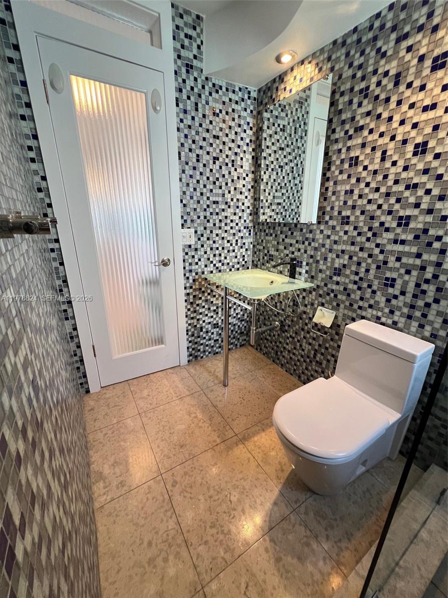 1340 Lincoln Road, Unit 705 Miami Beach, FL 33139 - Photo 12 of 21 a bathroom with a toilet and a shower