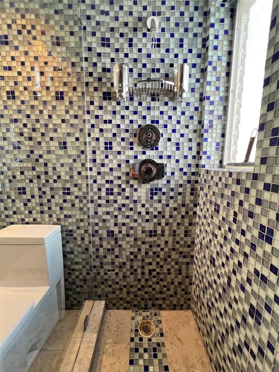 1340 Lincoln Road, Unit 705 Miami Beach, FL 33139 - Photo 13 of 21 a bathroom with a black and white shower curtain