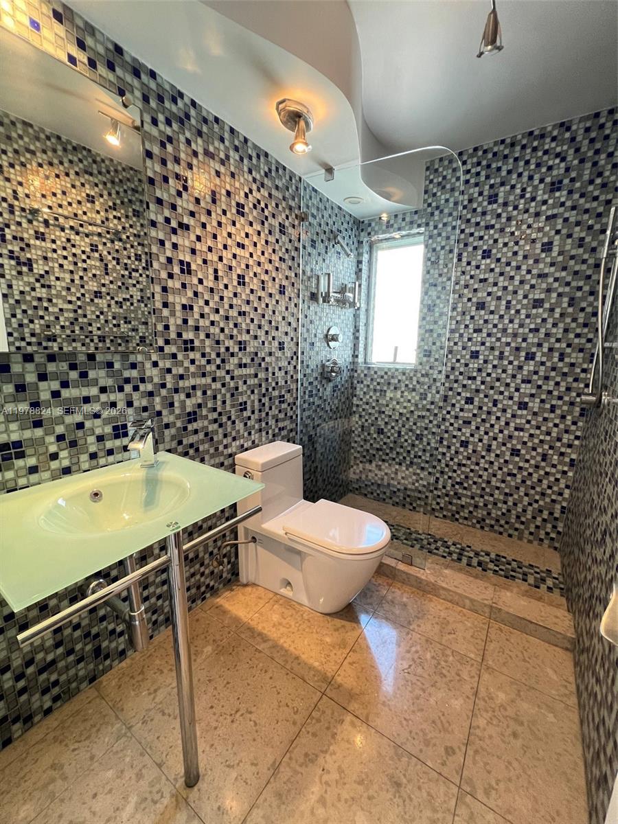 1340 Lincoln Road, Unit 705 Miami Beach, FL 33139 - Photo 2 of 21 a bathroom with a sink toilet and shower