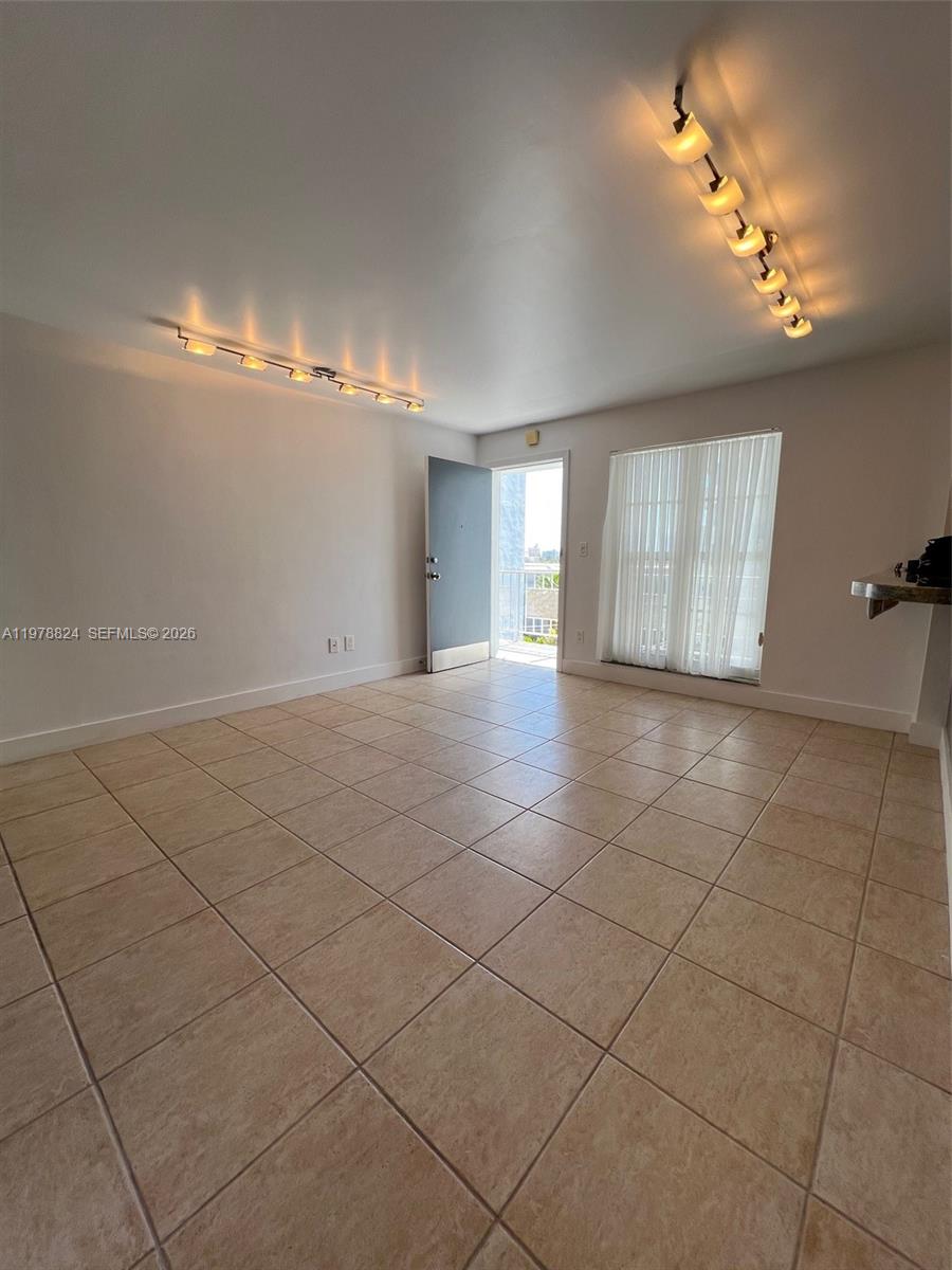 1340 Lincoln Road, Unit 705 Miami Beach, FL 33139 - Photo 6 of 21 a view of an empty room with a window