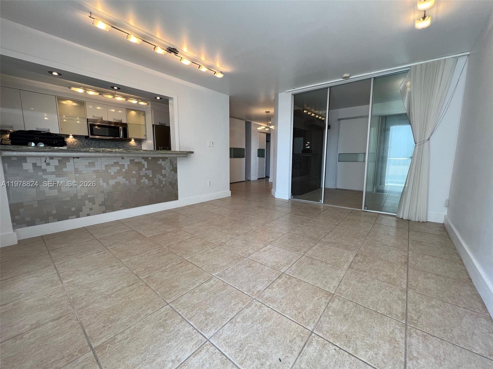 1340 Lincoln Road, Unit 705 Miami Beach, FL 33139 - Photo 7 of 21 a view of a big room with stainless steel appliances kitchen island granite countertop a refrigerator and a sink