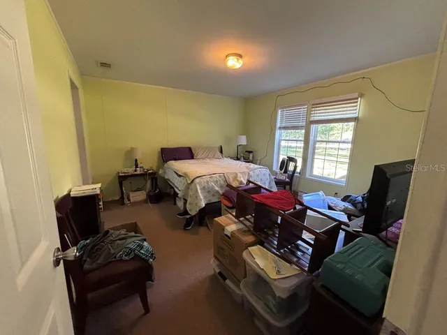 a bed sitting in a bedroom next to a window