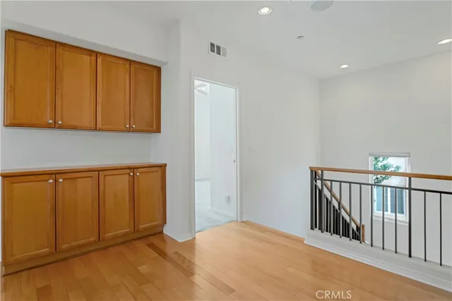 a view of hallway with wooden floor