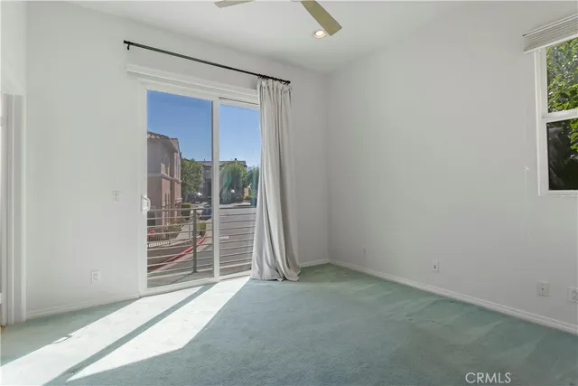 an empty room with walk in closet and window