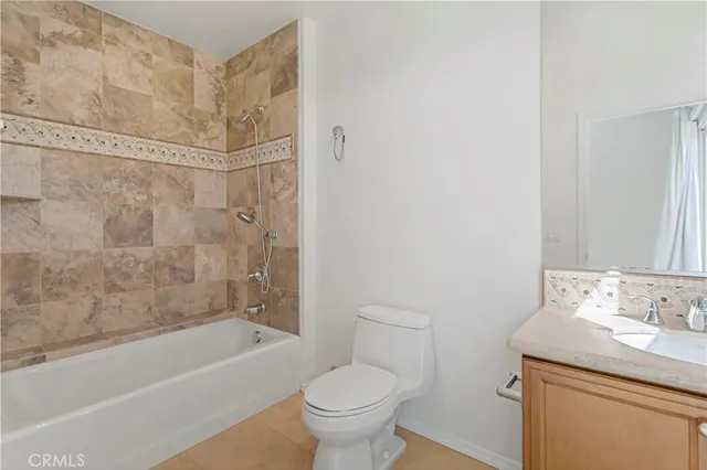a bathroom with a granite countertop toilet a sink and a bathtub