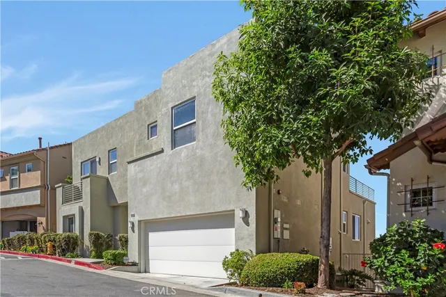 a spacious bedroom with a large bed and a potted plant