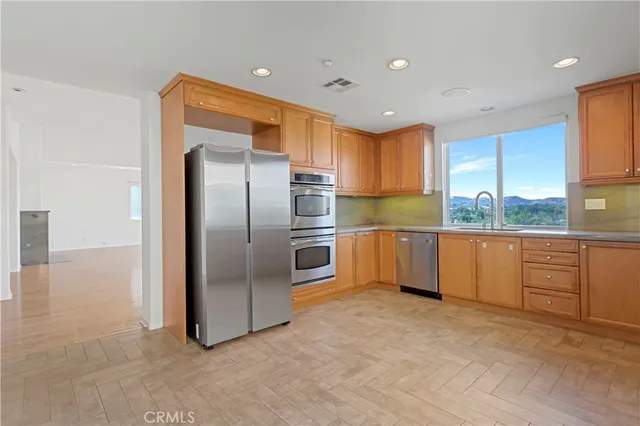 a kitchen with granite countertop a refrigerator and a sink