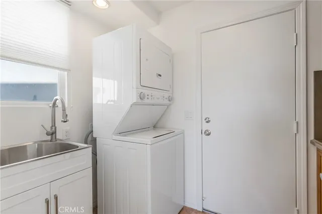 a view of a storage and utility room with closet dryer