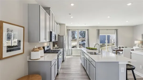 a kitchen with stainless steel appliances granite countertop a sink and stove