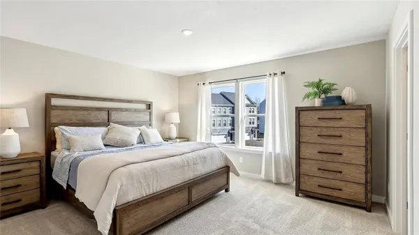 a bedroom with a bed and a dresser