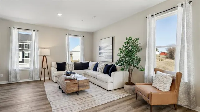 a living room with furniture and wooden floor