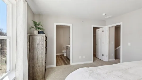 a bedroom with a bed and a large mirror