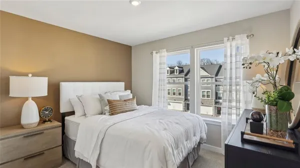 a bedroom with a bed and a night stand