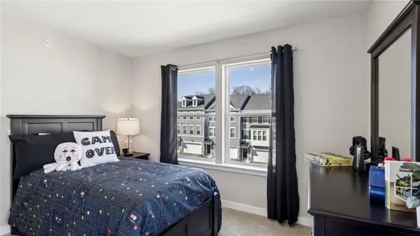 a bed sitting in a bedroom next to a window