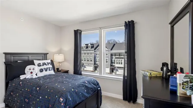 a bed sitting in a bedroom next to a window