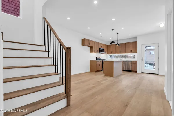 a kitchen with stainless steel appliances granite countertop a sink a stove and a refrigerator