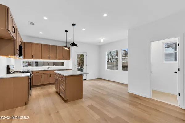 a view of a room with wooden floor and a bathroom