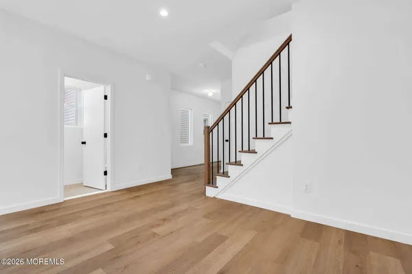 a view of a room with wooden floor and a window