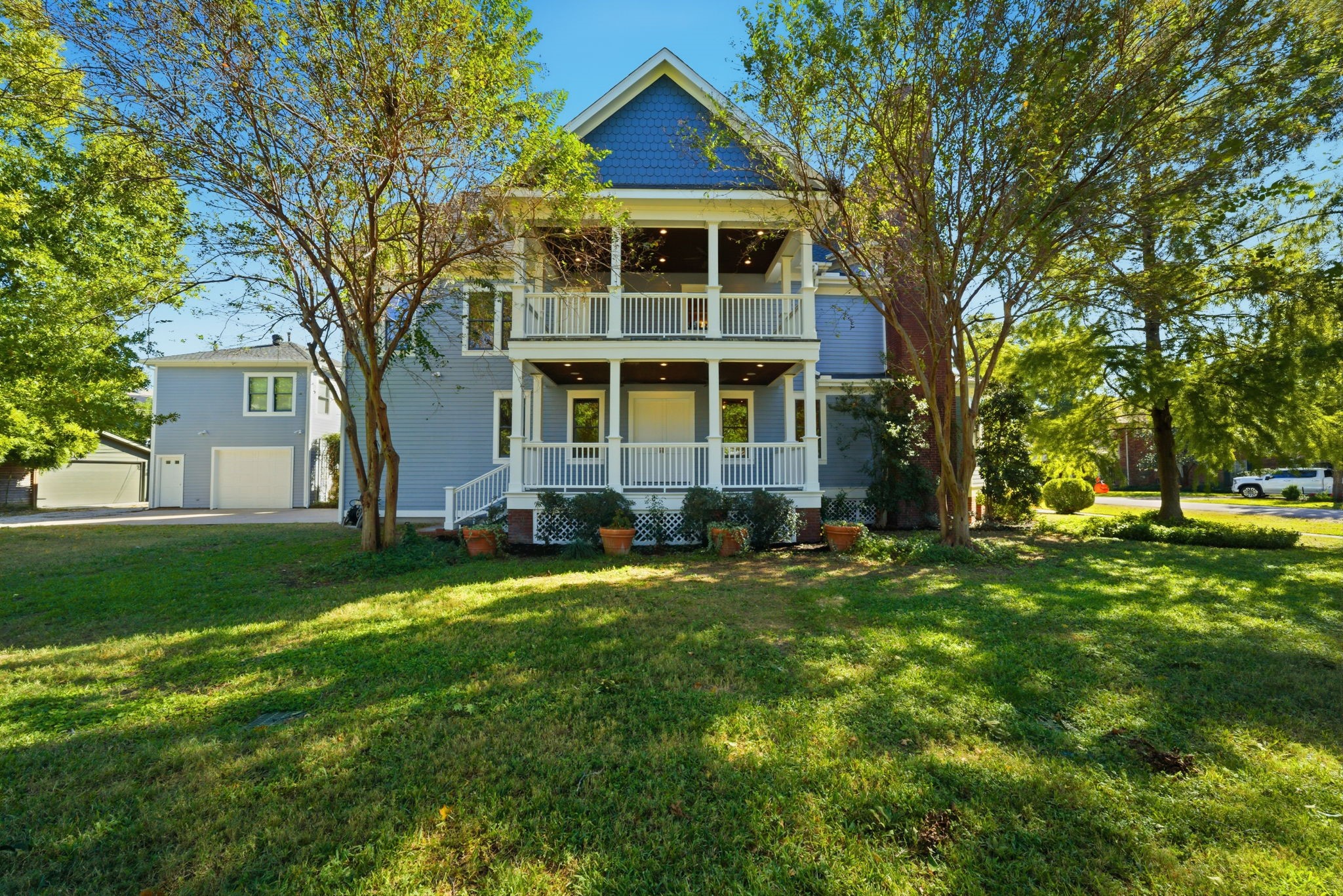 607 East 15th Street Houston, TX 77008 - Photo 1 of 50 Set on a 12,500 sq. ft. corner lot surrounded by mature trees. Your view as you walk out on the side porch from the family room double doors. The second floor balcony is private to the primary suite.