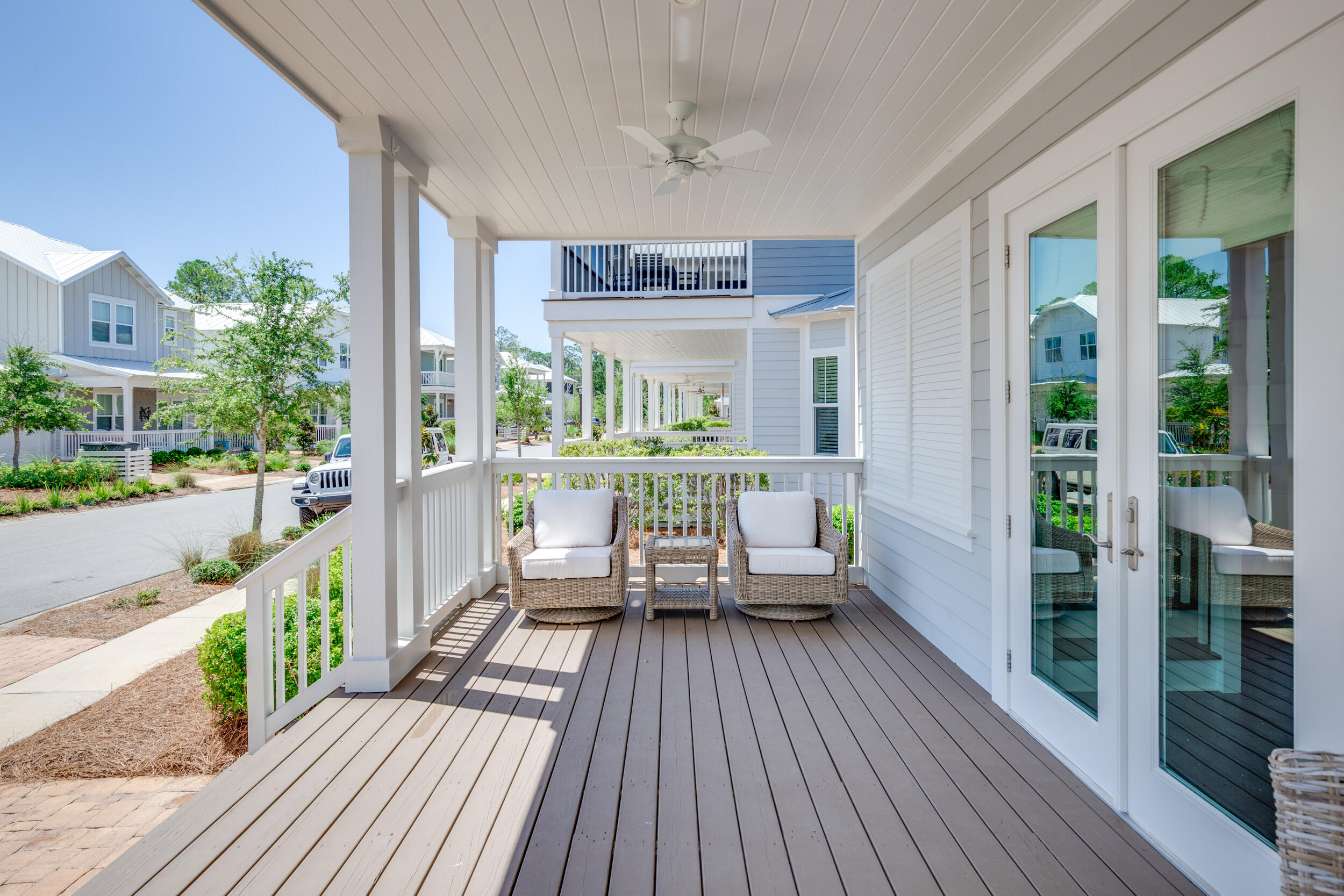 117 Prairie Pass Santa Rosa Beach, FL 32459 - Photo 3 of 33 a balcony with wooden floor table and chairs
