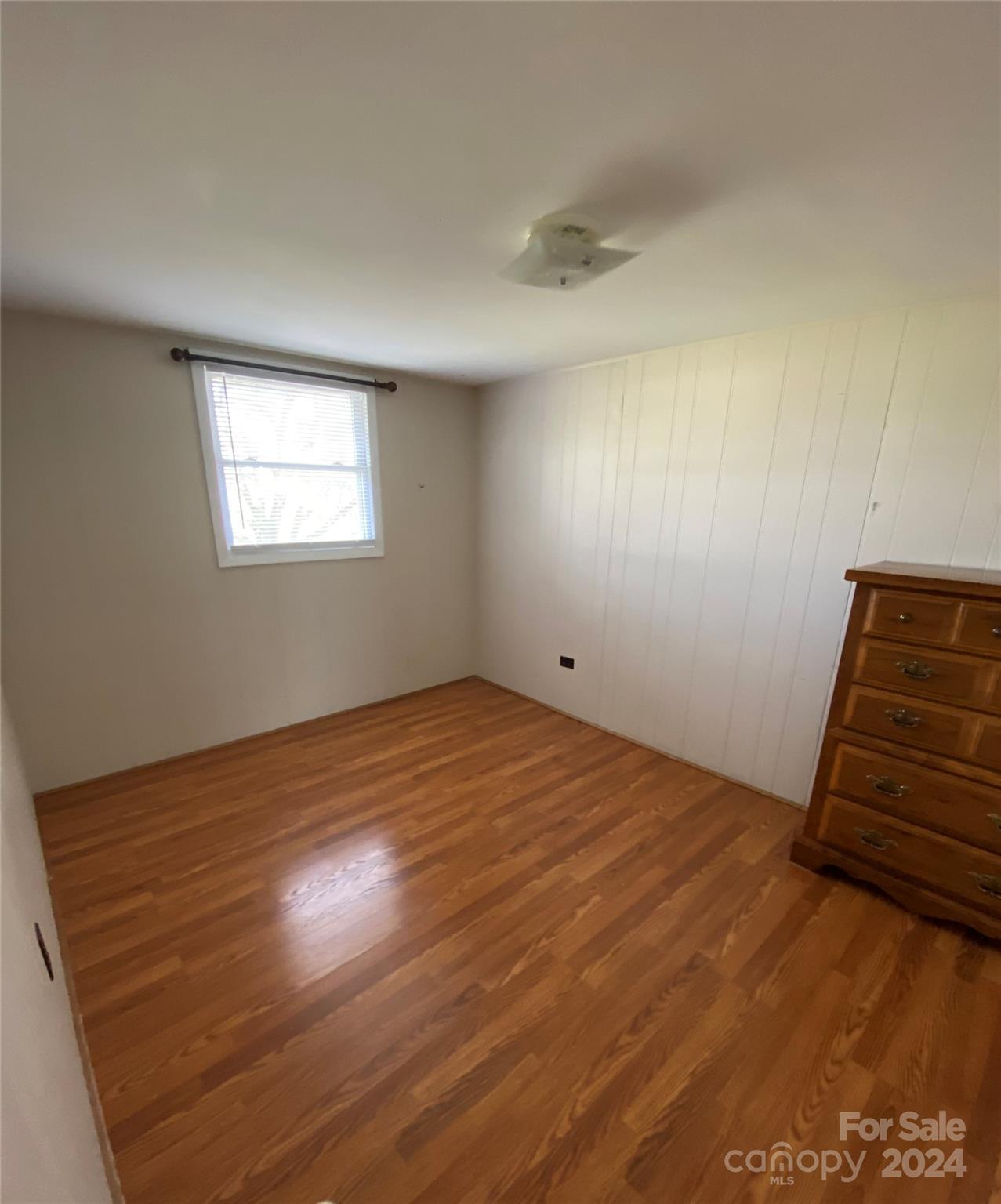 565 Neely Road Brevard, NC 28712 - Photo 19 of 28 an empty room with wooden floor and windows