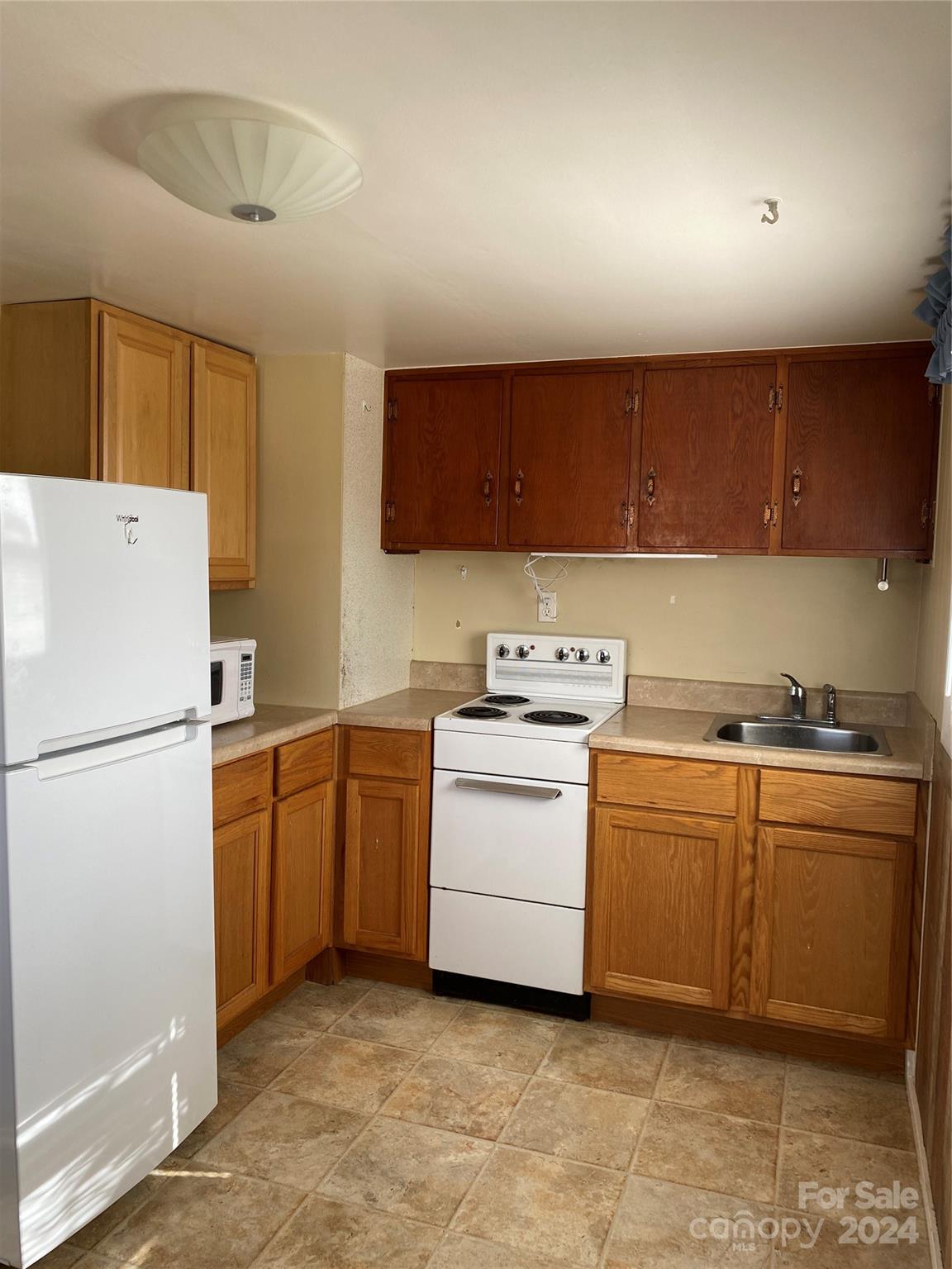 565 Neely Road Brevard, NC 28712 - Photo 20 of 28 a kitchen with a white cabinets and white appliances