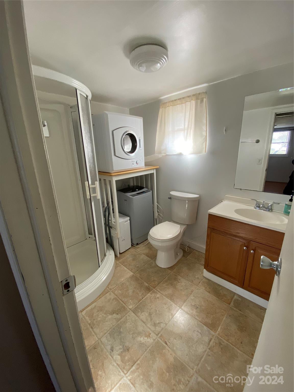 565 Neely Road Brevard, NC 28712 - Photo 21 of 28 a bathroom with a toilet sink and mirror