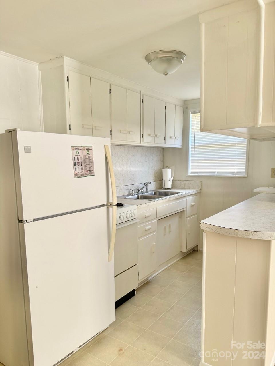 565 Neely Road Brevard, NC 28712 - Photo 26 of 28 a white refrigerator freezer sitting in a kitchen