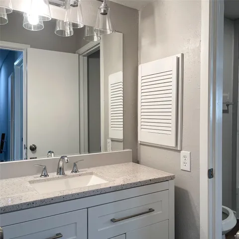 a bathroom with a sink vanity and mirror