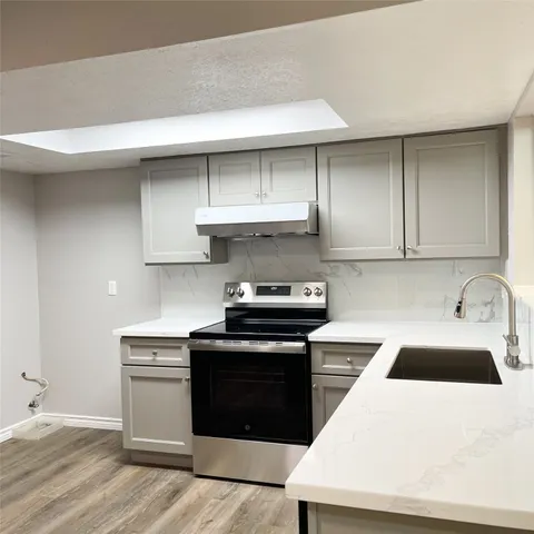 a stove top oven sitting inside of a kitchen