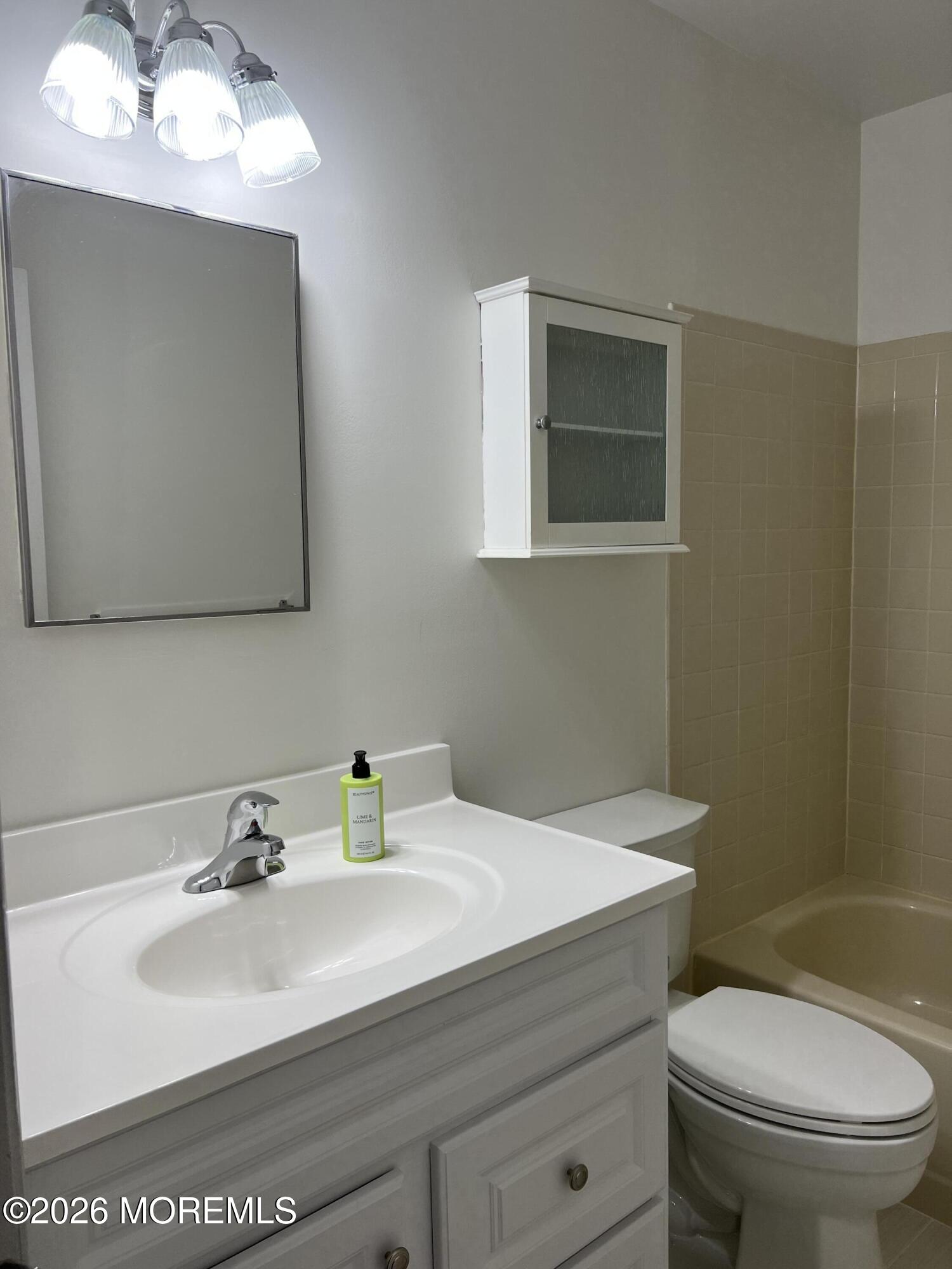 91 Paddock Court Oceanport, NJ 07757 - Photo 16 of 17 a bathroom with a sink toilet and mirror
