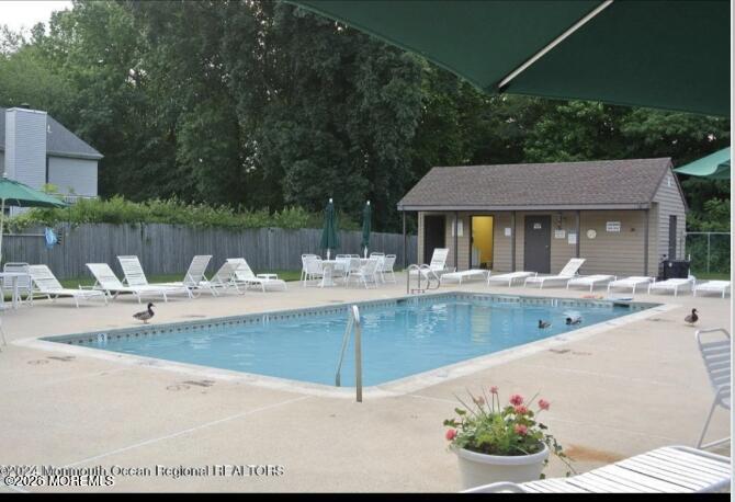 91 Paddock Court Oceanport, NJ 07757 - Photo 17 of 17 a view of a white house with a swimming pool and a yard