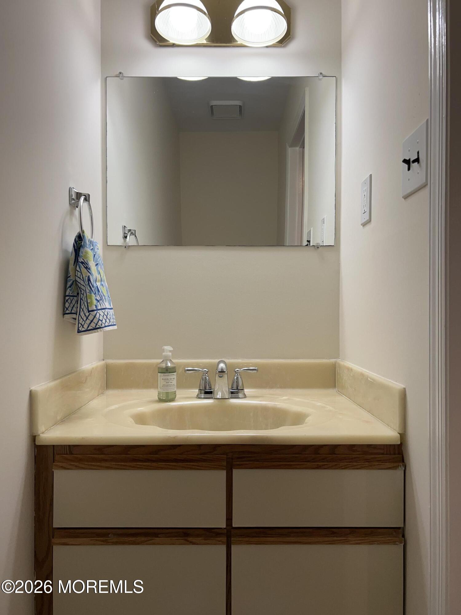 91 Paddock Court Oceanport, NJ 07757 - Photo 8 of 17 a sink with a mirror