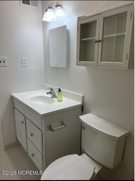 91 Paddock Court Oceanport, NJ 07757 - Photo 9 of 17 a bathroom with a sink mirror vanity and toilet