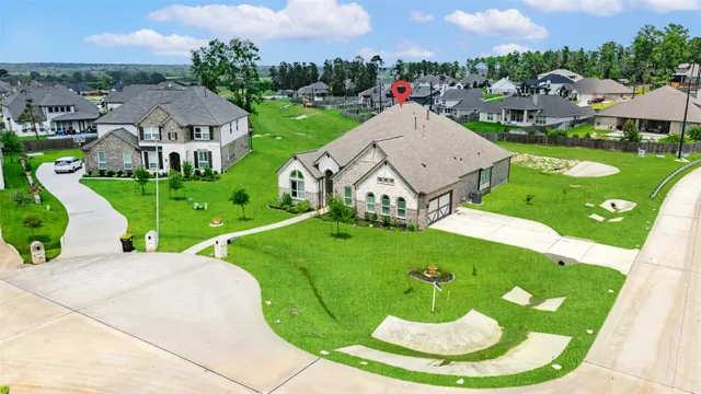 a view of a house with a yard and potted plants