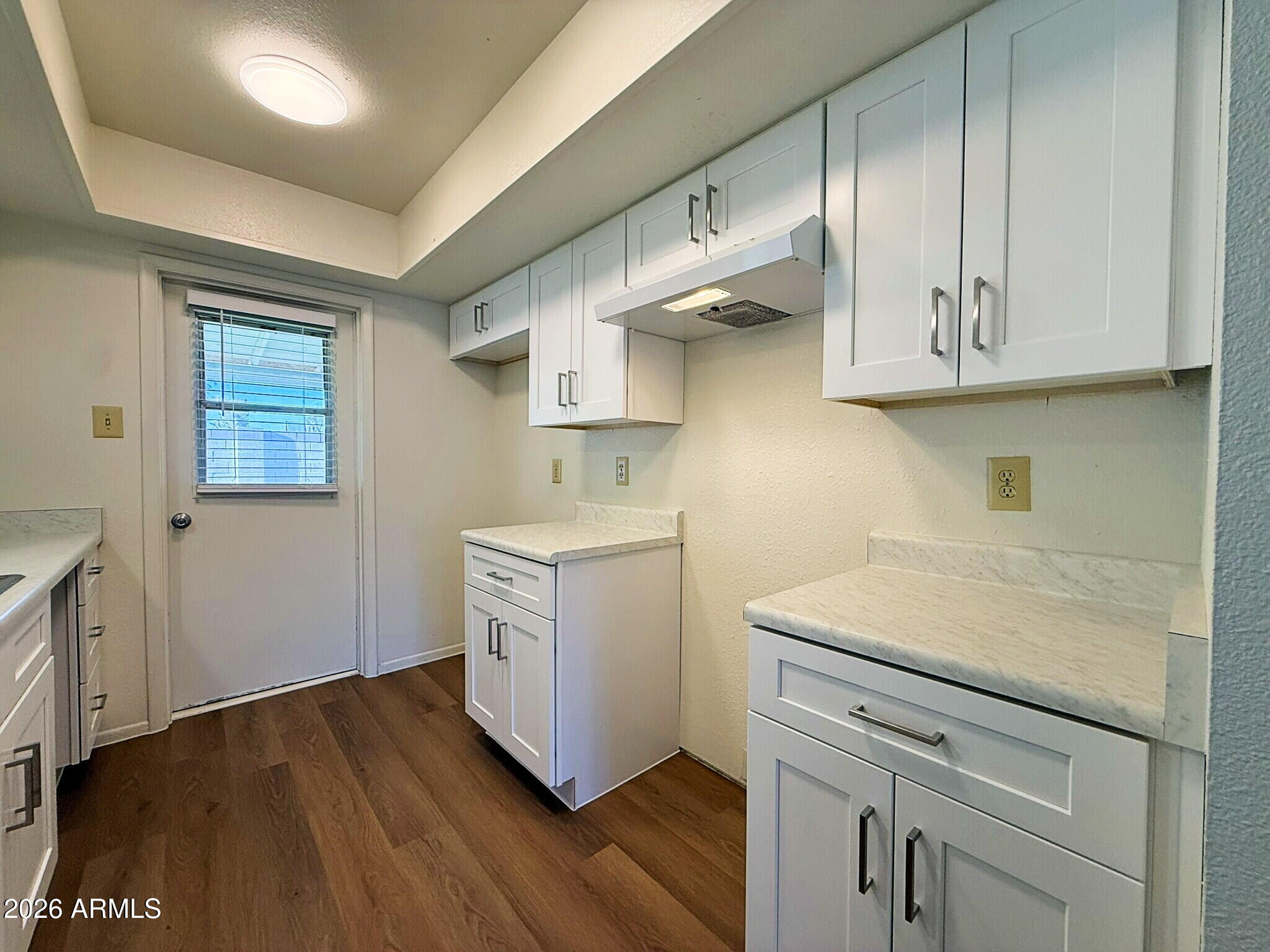 5208 West Calavar Road Glendale, AZ 85306 - Photo 30 of 39 a kitchen with cabinets and wooden floor