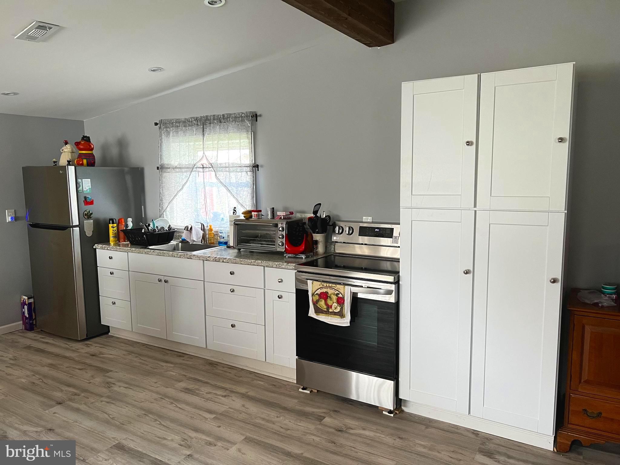 3 Canhouse Road Elmer, NJ 08318 - Photo 25 of 44 a kitchen with a refrigerator and white cabinets