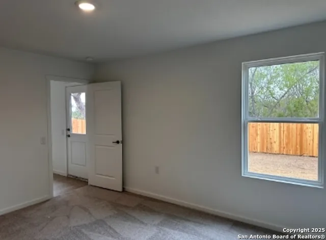 an empty room with windows and closet
