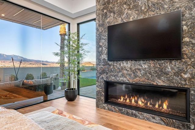 2867 East Granite Way St. George, UT 84790 - Photo 25 of 69 Contemporary living space featuring a floor-to-ceiling stone accent wall with an integrated linear fireplace