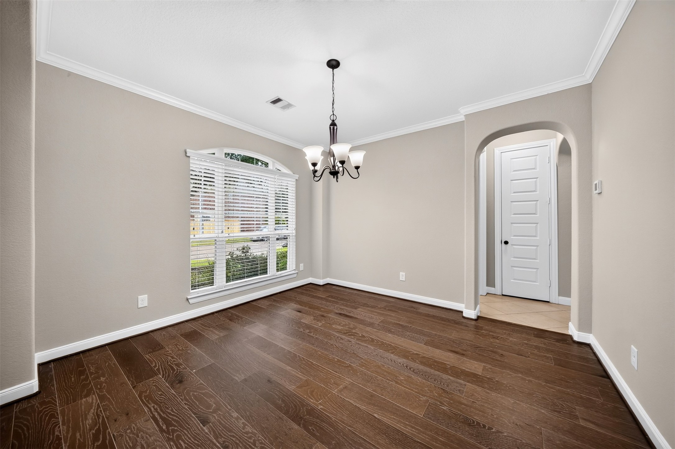 6234 Avon Landing Lane Spring, TX 77379 - Photo 6 of 49 The formal dining room has lots of natural light, a chandelier, neutral tones and crown moldings.