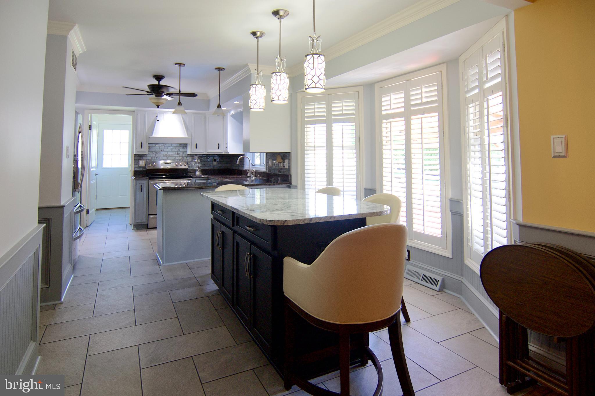 7451 Valley View Lane Reading, PA 19606 - Photo 14 of 61 a kitchen with a table chairs sink and cabinets