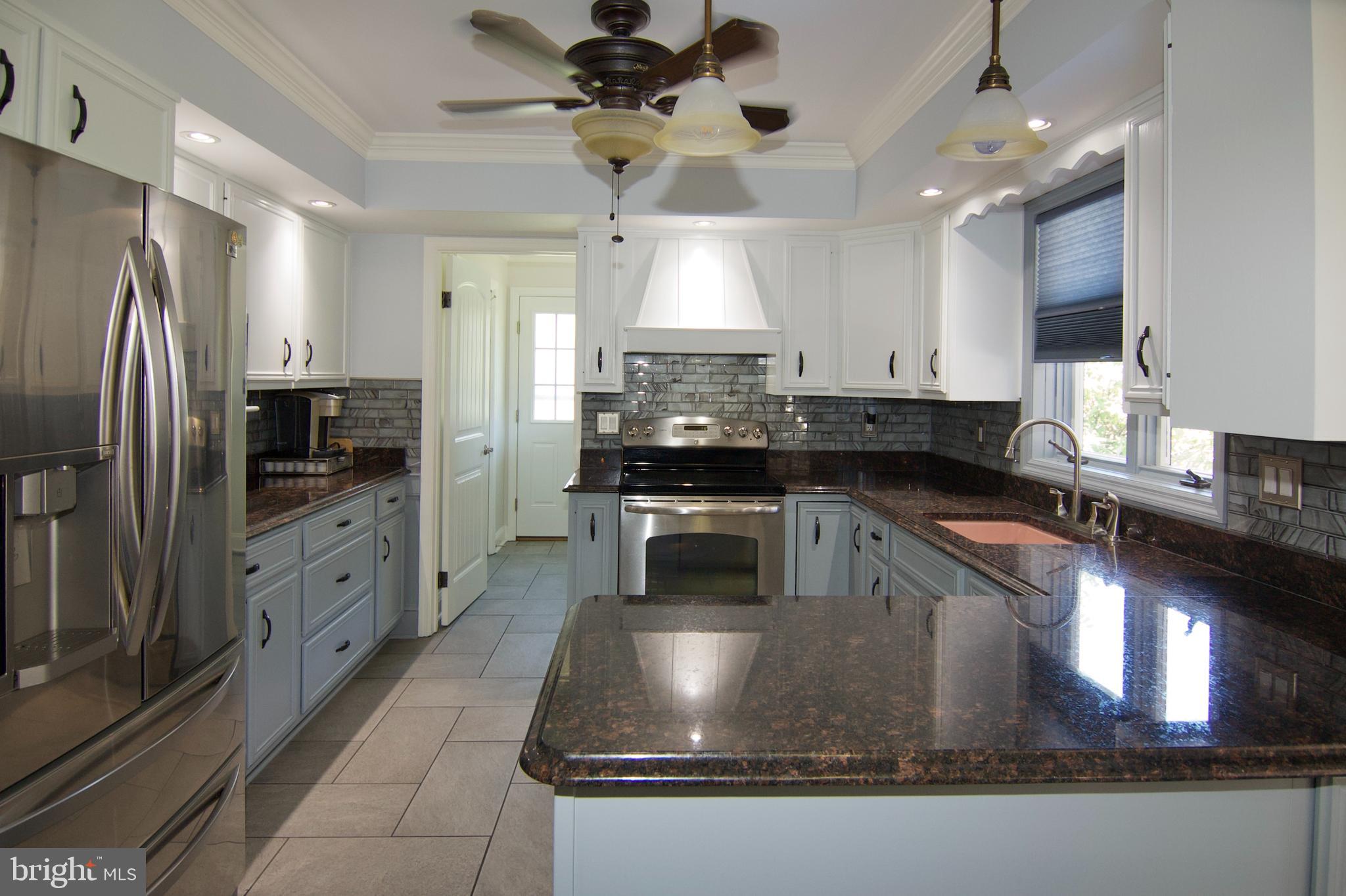 7451 Valley View Lane Reading, PA 19606 - Photo 16 of 61 a kitchen with stainless steel appliances granite countertop a sink a stove counter space and cabinets